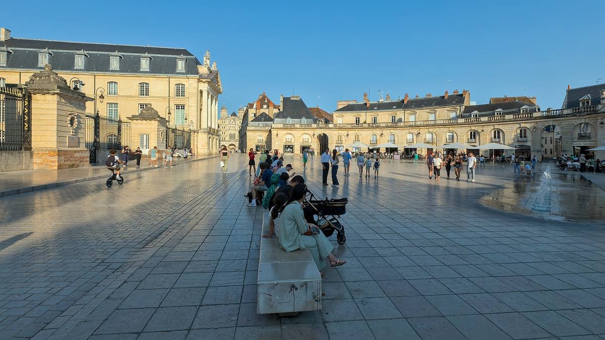 La place de la Libération à Dijon en fin de journée, avec ses arcades en hémicycle et le palais des ducs de Bourgogne
